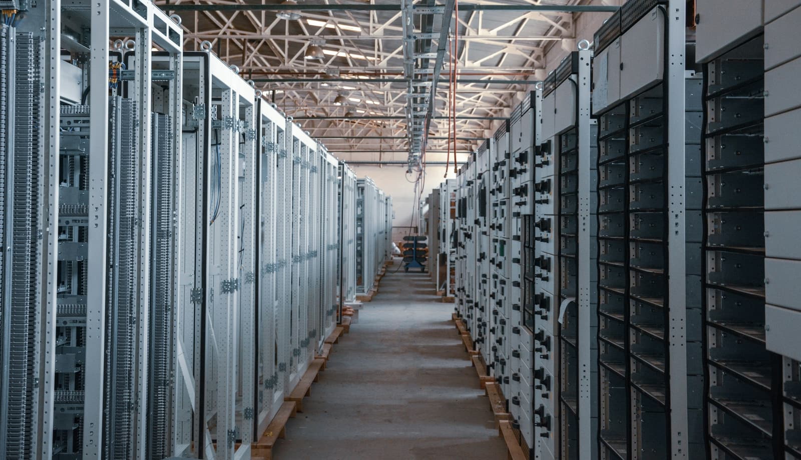Long aisle of populated equipment racks inside an enterprise facility