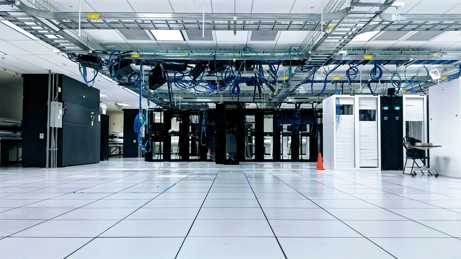 A bright, ordered data hall with rows of equipment cabinets