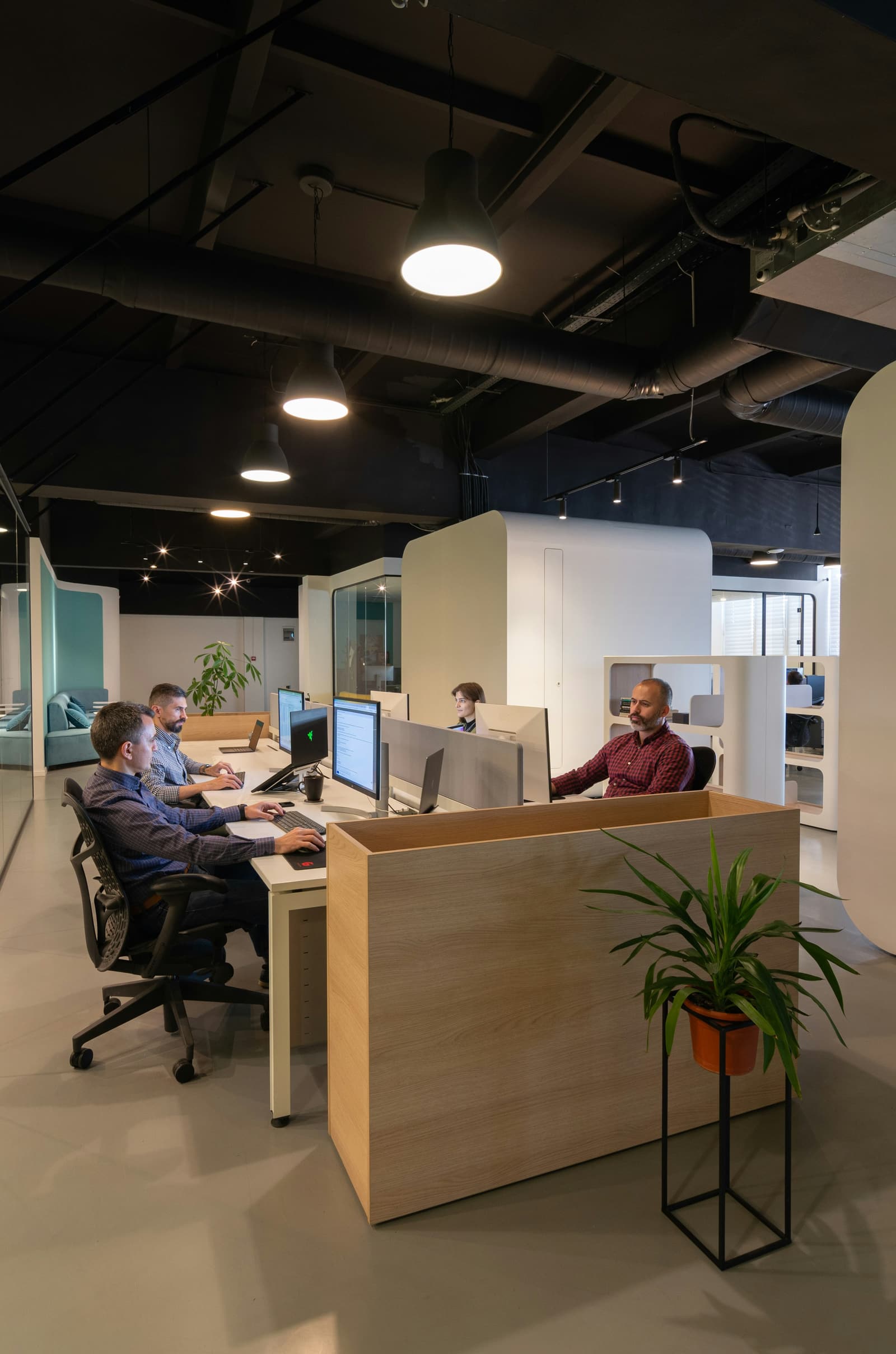 Engineers working together at a shared workstation